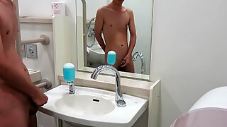 Japanese guy naked and pissing in public toilet