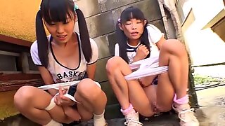 Kleines japanisches Schulmädchen, das Eis isst